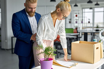 young business man harassing office woman sexually in modern office, male touch her waist from back.