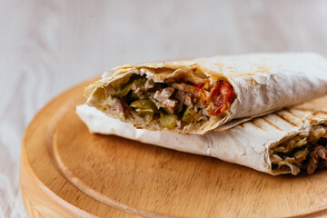 Turkish Shawarma on a wooden Board and light background