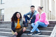 © iordani - cute group of teenages at the building of university with books huggings, diversity nations real students lifestyle