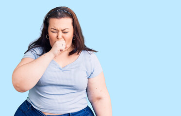 Young plus size woman wearing casual clothes feeling unwell and coughing as symptom for cold or bronchitis. health care concept.