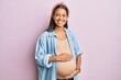 © Krakenimages.com - Beautiful hispanic woman expecting a baby, touching pregnant belly smiling with a happy and cool smile on face. showing teeth.