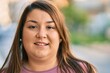 © Krakenimages.com - Young hispanic plus size woman smiling happy standing at the park.