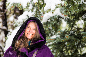 Wall Mural - A portrait of a very happy woman outside in the nature on a cold wintery day