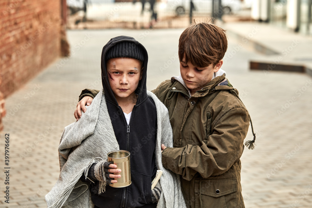 Stock-Foto „two homeless children ask for help in the street, at street in  big city, begging. shelter concept.“ | Adobe Stock