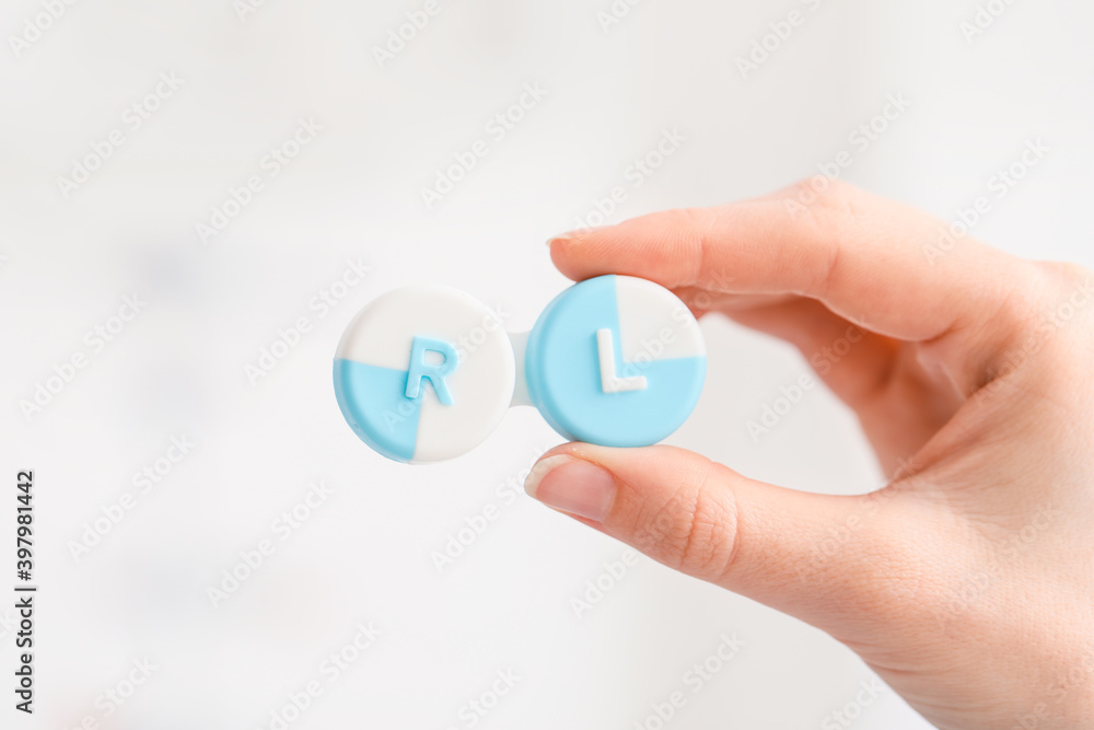 Woman holding contact lens case