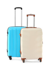 Packed suitcases on white background