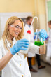 © NDABCREATIVITY - Attractive young woman scientist working in laboratory