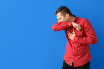 Poster - Coughing young man on color background