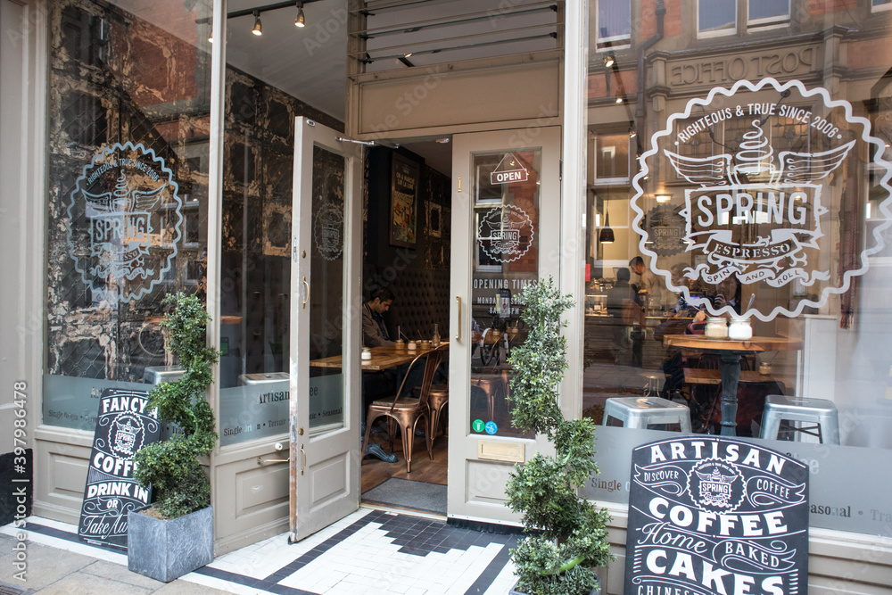 Entrance to Spring Cafe with signage, windows and open door Stock Photo ...