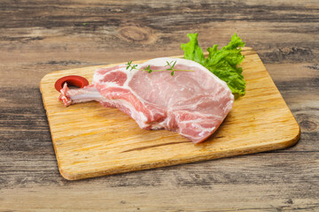 Raw pork bone steak over wooden