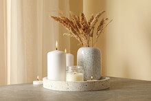 Tray With Scented Candles And Reed On Gray Table