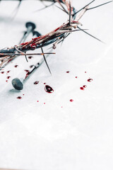 Bloody nails, crown of thorns, drops of blood on grey stone background. Good Friday, Passion of Jesus Christ. Christian Easter holiday. Crucifixion, resurrection of Jesus Christ. Gospel, salvation