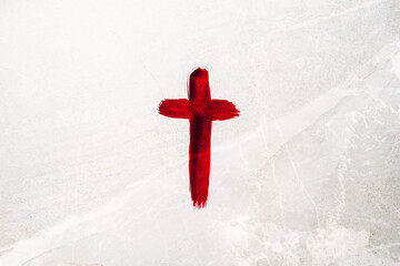 Crucifix made of blood. Good friday. Easter holiday. Christian cross painted with blood on stone background. Passion, crucifixion of Jesus Christ. Gospel, salvation concept