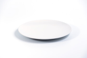 Wall Mural - Empty White plate isolated on white background side view, selective focus