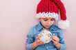 © Kateryna - Baby boy in Santa Clause hat and Christmas tree toys