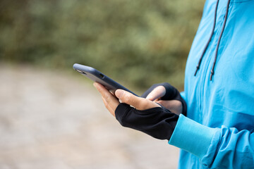 Wall Mural - woman runner using smartphone on trail