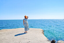 Red Haired Woman In Long Dress Standing Summer Sea Pier By Blue Sky