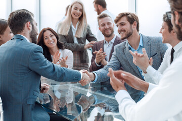 business people shaking hands sitting at the office Desk