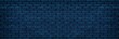 © JAYANNPO - Navy blue brick wall wide texture. Dark block masonry large widescreen background. Gloomy night indigo backdrop