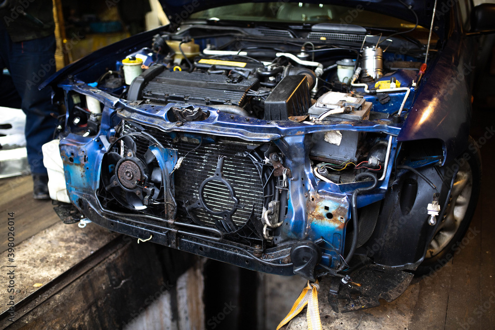 car is in emergency condition, disassembled hood and bumper, broken ...