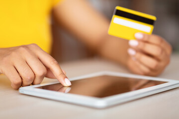 Black woman using tablet and credit card