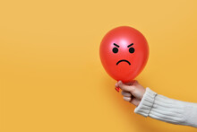 A Balloon With An Angry Face In The Hand Of A Man. Anger In A Person. Negative Emotions In A Person