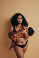 Wall Mural - Plus size mother breastfeeding her baby