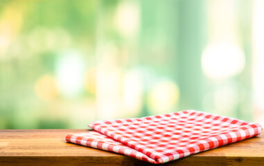 Cloth napkin on wood table with glass window background