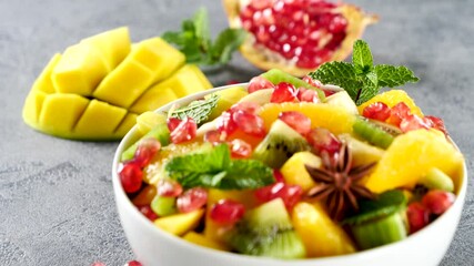 Wall Mural - colorful fruit salad with mango, pomegranate and spices