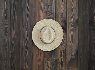 Poster - straw rustic hat on a wooden wall