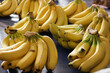 © DenisProduction.com - Bunches of ripe bananas on market stall. Ripe big bananas on counter of the grocery store. Delicious tropical fruit.