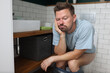 Man sit on toilet with constipation and wait for laxative to take effect. Digestive system disease and treatment.