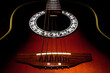 © Rix Pix - Close up of acoustic guitar on black background