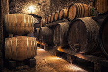 Wooden Barrels With Wine In A Wine Vault