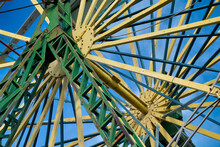 Detail Of The Green And Yellow Rusty Metal Bars Of The Structure Of A Ferris Wheel