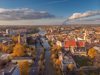 Wall Mural - A drone view of the historic city with the market square, churches, town hall and the castle tower in Opole during sunset. Autumn in Silesia - Poland.