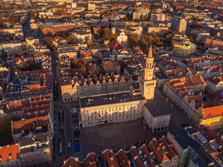 Wall Mural - A drone view of the historic city with the market square, churches, town hall and the castle tower in Opole during sunset. Autumn in Silesia - Poland.