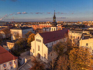 Wall Mural - A drone view of the historic city with the market square, churches, town hall and the castle tower in Opole during sunset. Autumn in Silesia - Poland.