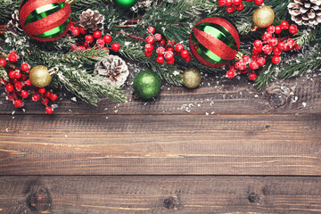 Canvas Print - Fir tree branches with christmas ornaments on brown wooden table