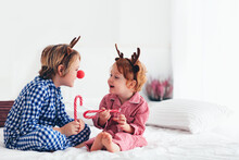 Laughing Kids, Brothers Wearing Reindeer Antlers Celebrate Christmas Holidays At Home