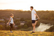 © Svetlana - Father and cute daughter doing yoga outside in bright sunny day, lovely emotions. together at park. Family stretching after sport. Healthy habits