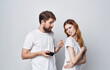 © SHOTPRIME STUDIO - man and woman in white t-shirts with phones in hands romance communication technology