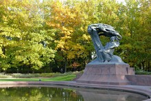 Warsaw, Poland. Frederic Chopin Monument. Large, Bronze Statue Of Frederic Chopin Located  In The Upper Part Of Warsaw's Royal Baths. Autumn Time