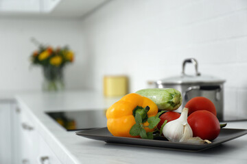 Wall Mural - Different fresh vegetables on countertop in modern kitchen. Space for text