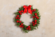Beautiful Christmas Wreath With Festive Decor On Light Wall