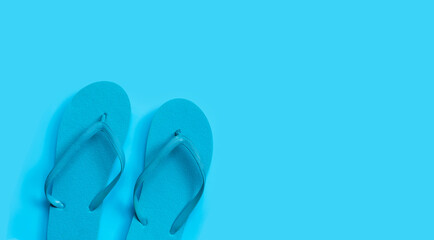 Canvas Print - Blue flip flops on blue background.