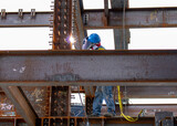 site worker welding steel structure for a skycraper