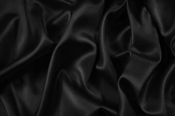 Wall Mural - Black silk satin fabric background. Black elegant background. Dark liquid wave or black silk with wavy folds.