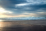 Fototapeta Zachód słońca - Sunset on the beach. Stormy ocean and beautiful cloudy sky on background