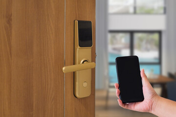 Hotel door security Unlocking by application on mobile phone. Digital door lock, keyless system of access door. Close up and selective focus.